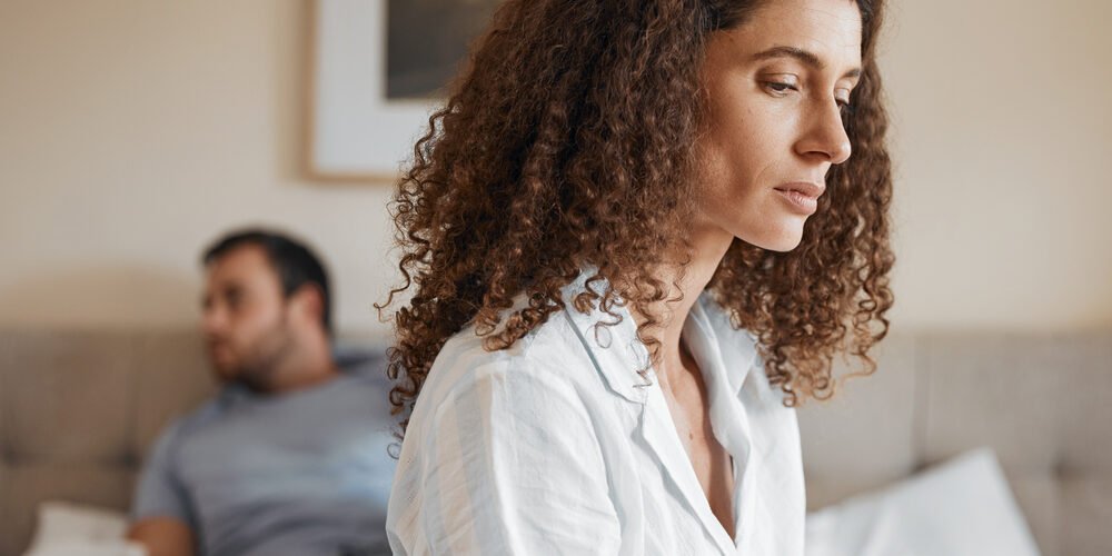 Upset, bedroom and woman in argument with her husband for divorce, marriage problem or breakup. Sad, depression and female person fighting with her partner for toxic relationship or cheating at home.