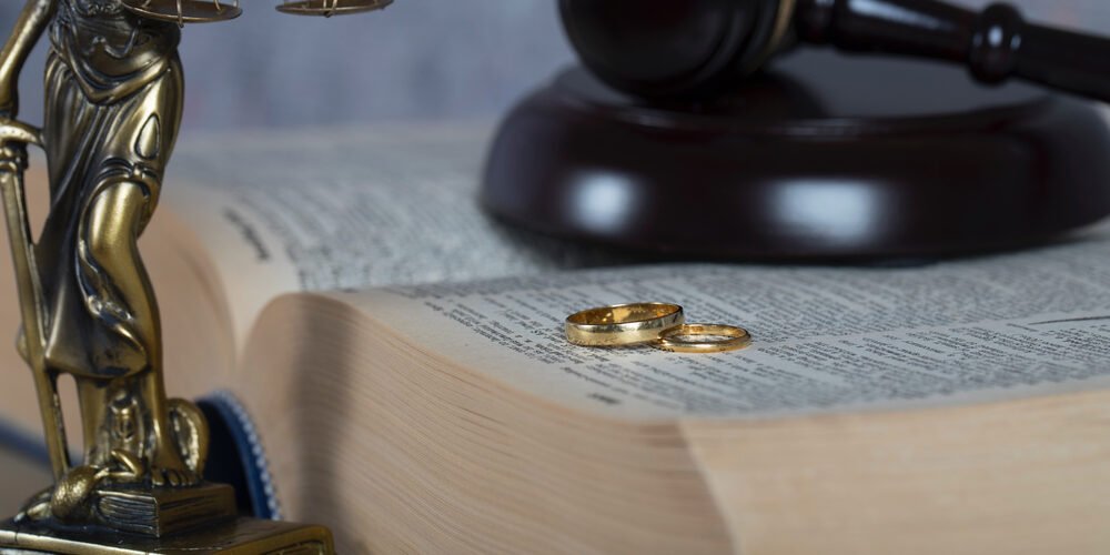 Marriage rings on a thick book.