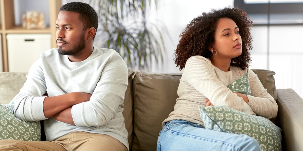unhappy couple having argument at home
