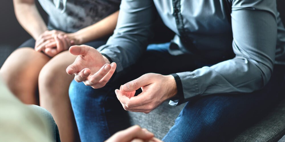 Divorced couple discussing spousal support with a family lawyer