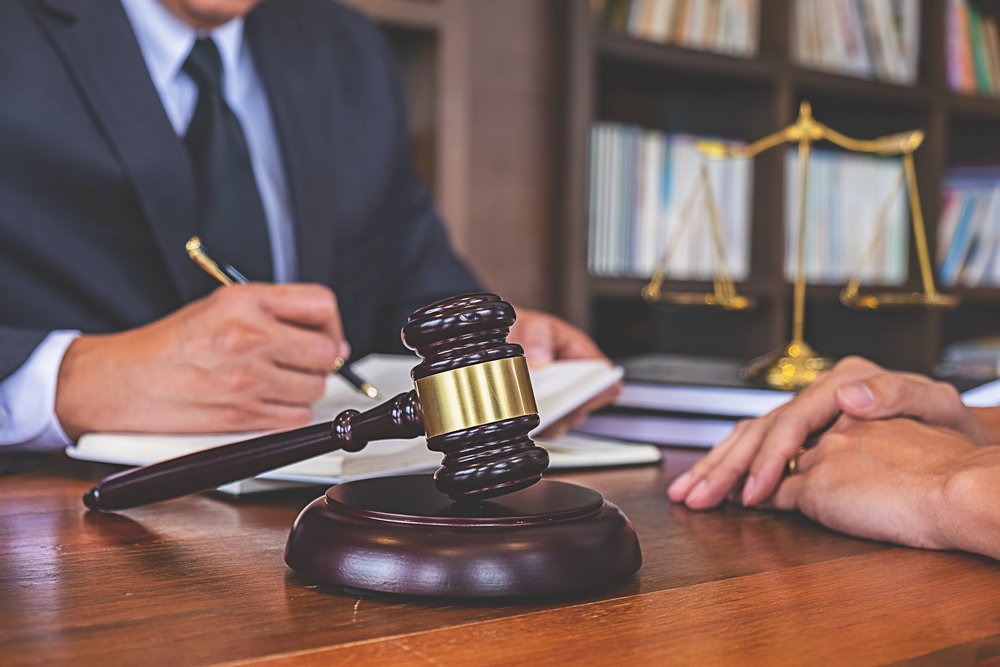 Lawyer discussing estate planning updates with a client to safeguard generational wealth during divorce.