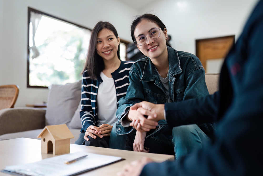 Business owner reviewing trust documents with a lawyer to safeguard family wealth during divorce.