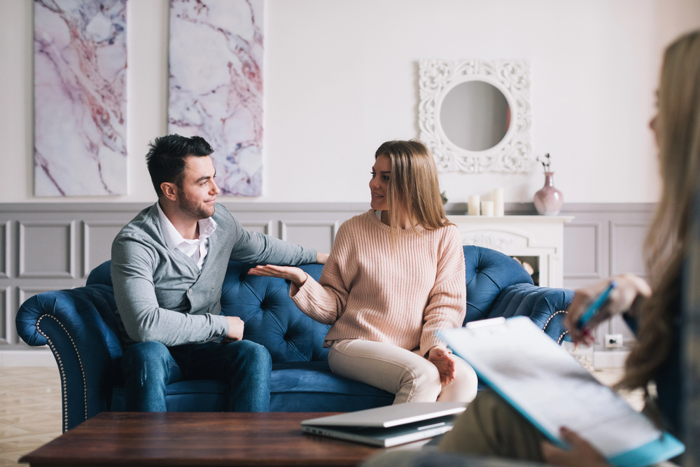 Couple consulting with a professional during divorce proceedings, focusing on strategies to protect business interests and intellectual property.