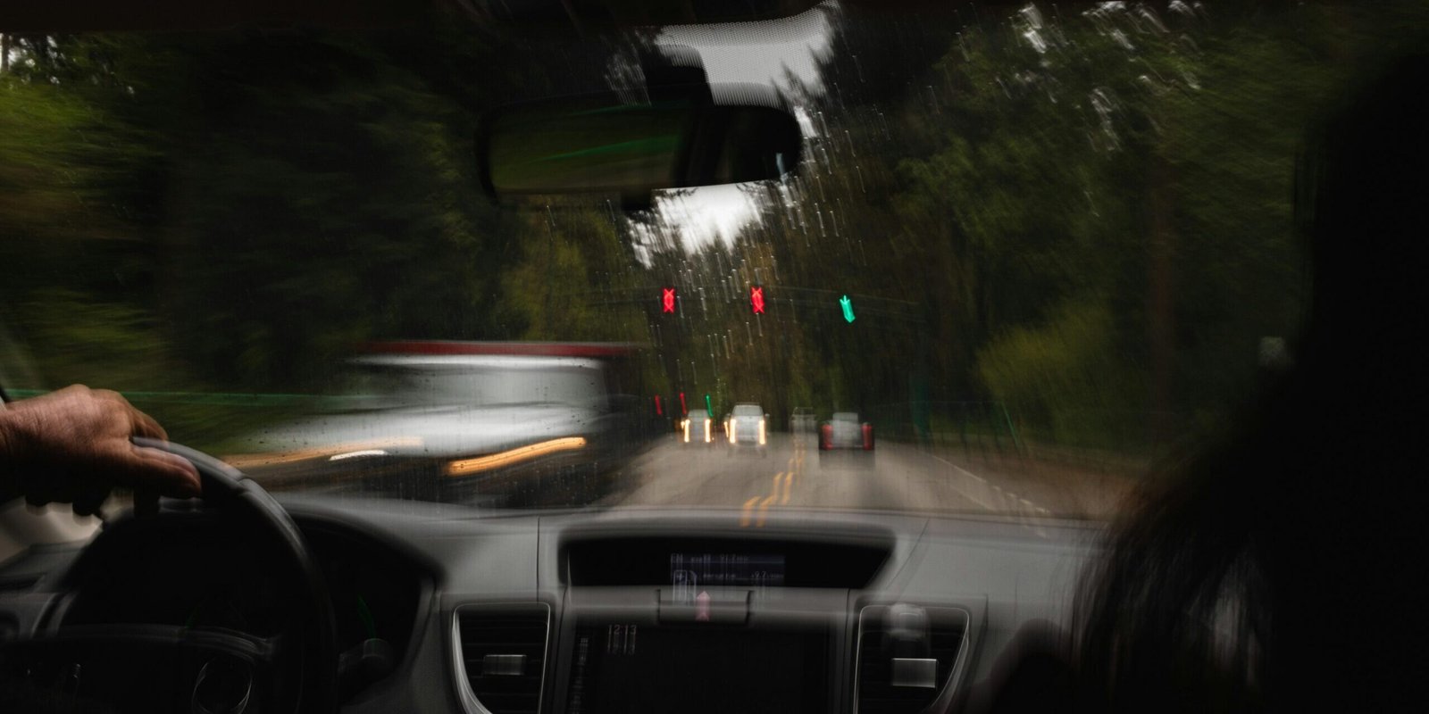 aedrian-salazar-Gl9fJzqlVMQ-unsplash Blurry police car passing car.