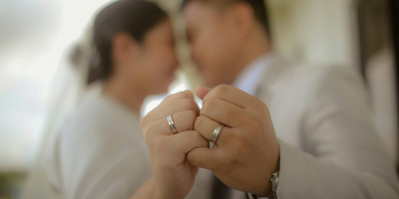 roxanne-andrea-dychengco-jCTZH8A1x6o-unsplash A couple holding up wedding rings.